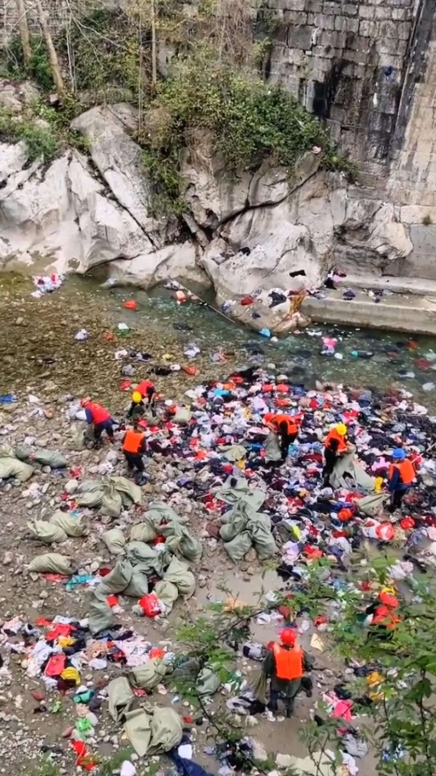 Authorities Clean River At Tourist Site Of Piles Of Clothes Thrown By Visitors For Good Luck