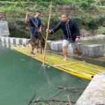 Two Men And Pet Dog Plunge Into River During Photoshoot Gone Wrong